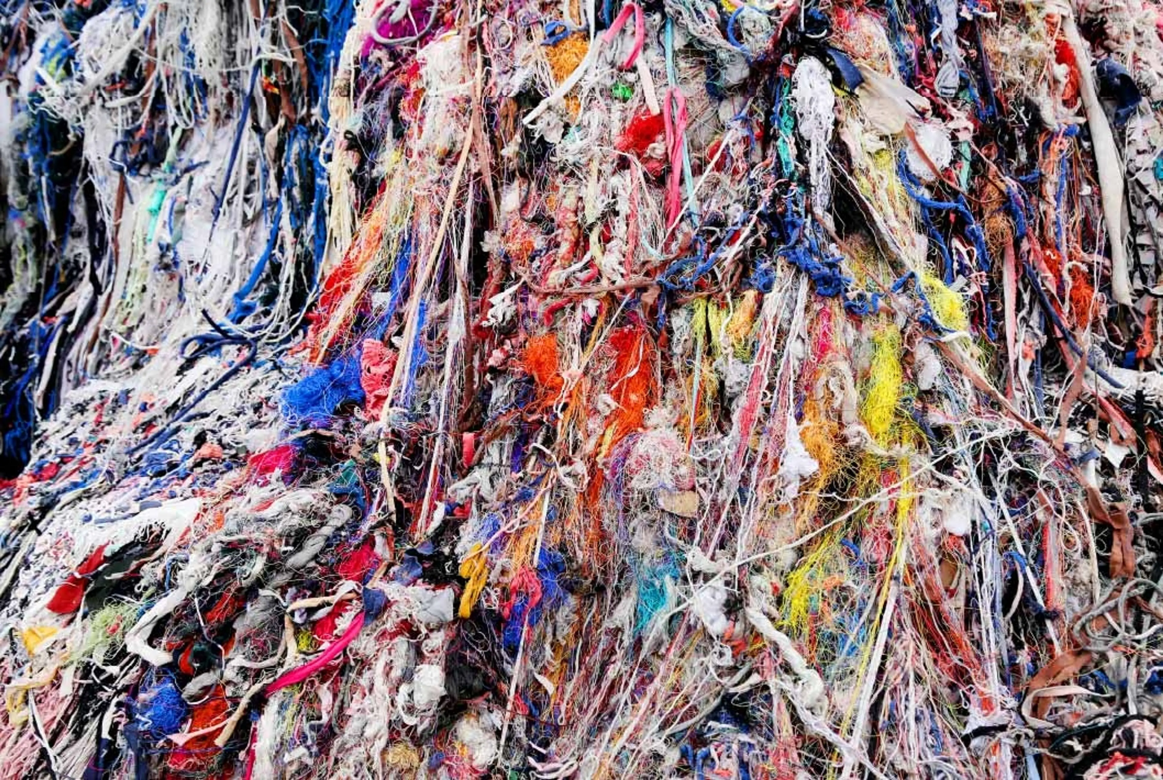 A vibrant pile of assorted textiles showcasing a variety of colors and textures.